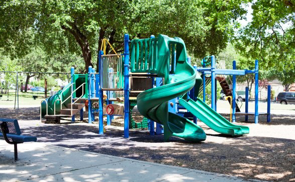 Playscape with green twisty slide.