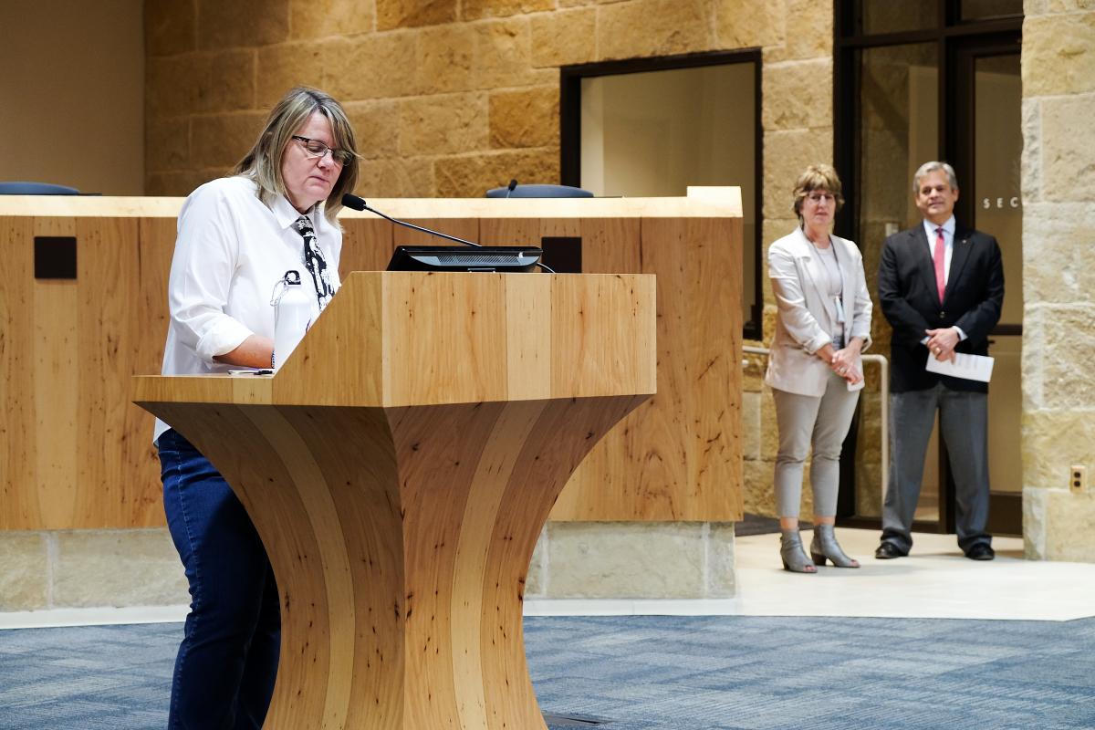 Mary Priddy speaking at podium