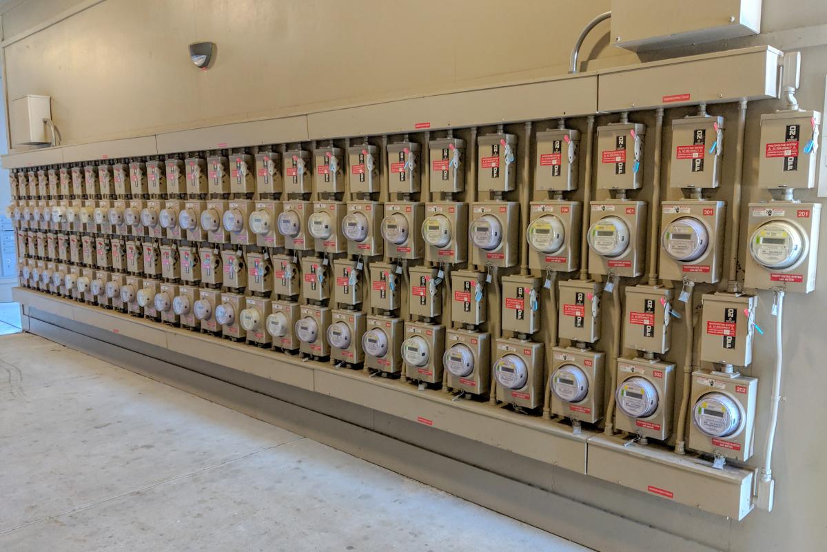 Large beige wall lined with solar energy meters.