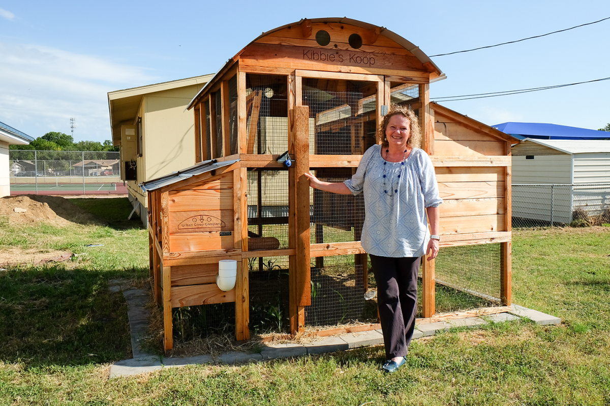 Sherry Lepine in front of chicken coop