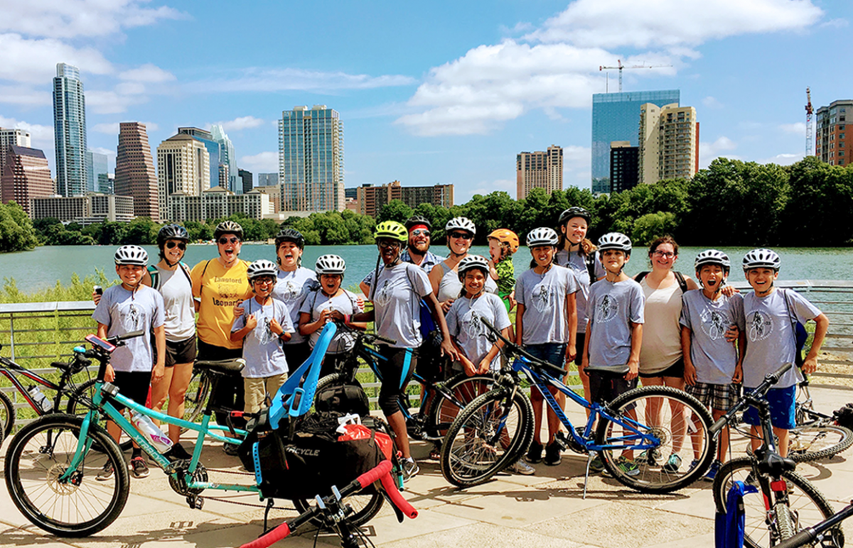 Langford Cycling Academy students pose with Austin skyline in background.