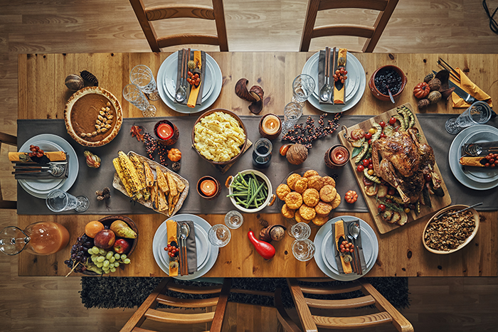 A zero waste table set for Thanksgiving, with reusable items like plates, glassware, silverware and napkins