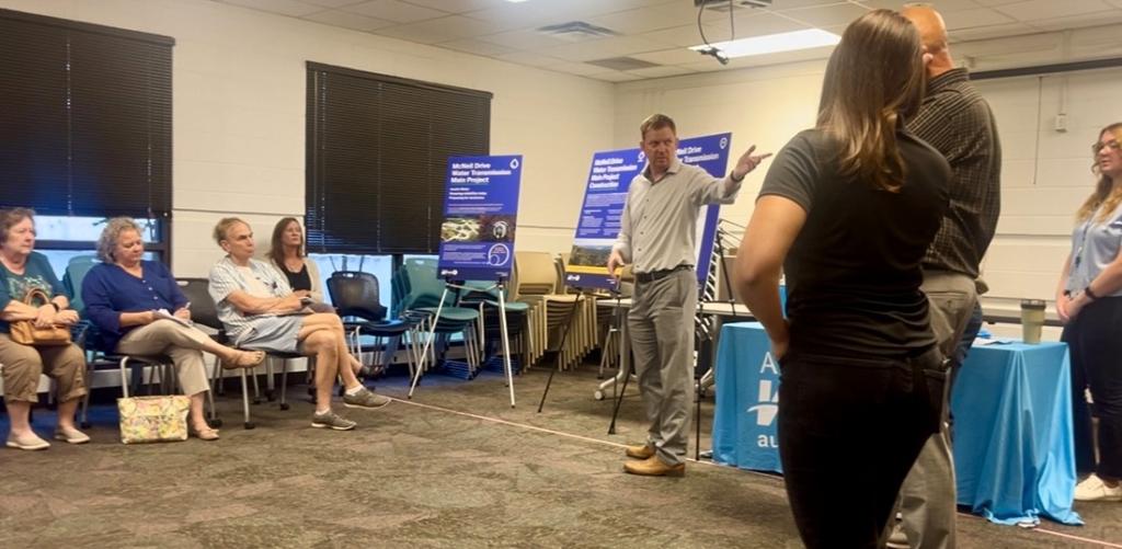 Audience members participating in a project open house event for the McNeil Transmission Main project in September 2025