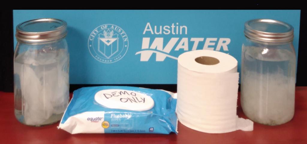 Image of toilet paper roll, mason jars, and non-flushable wipes, broken down in jars of water.