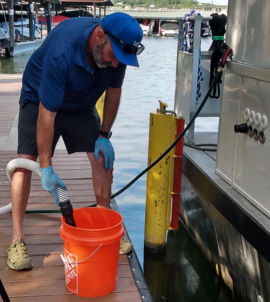 man using a 5 gallon bucket to run pump for additional 30 seconds