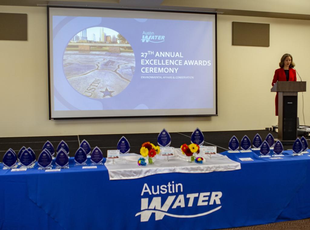 image of an Austin Water Banner with a presentation on a projector screen