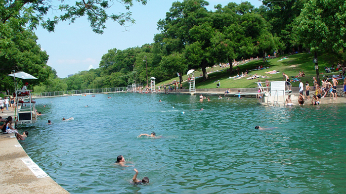 people swimming in Barton Springs Pool in Austin, TX.