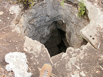 .  A natural underground cavity, chamber or series of chambers formed by the dissolution of limestone by surface or groundwater.  