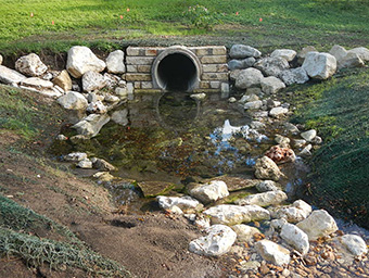 Figure 2.  The same location as above, shortly after construction.  A sections of the pipe has been removed and replaced by a winding swale.