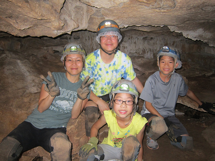 A family in a cave at Clean Creek Camp.
