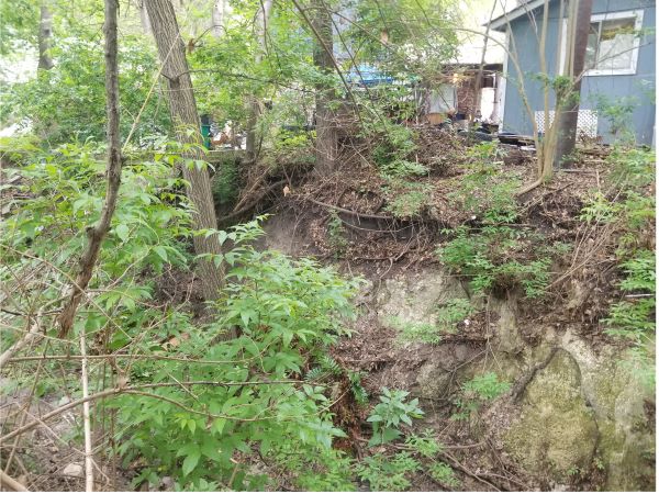 Photo showing erosion close to a house.