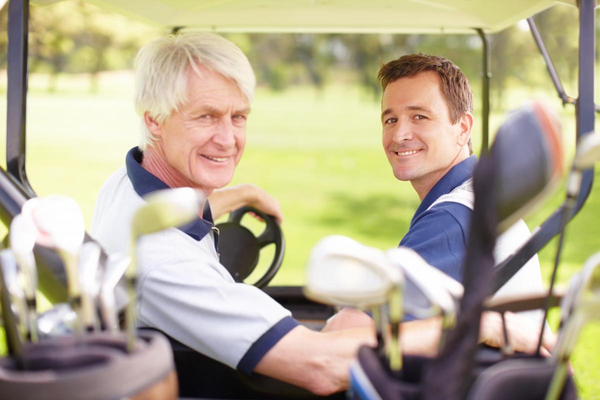 Father and son in golf cart