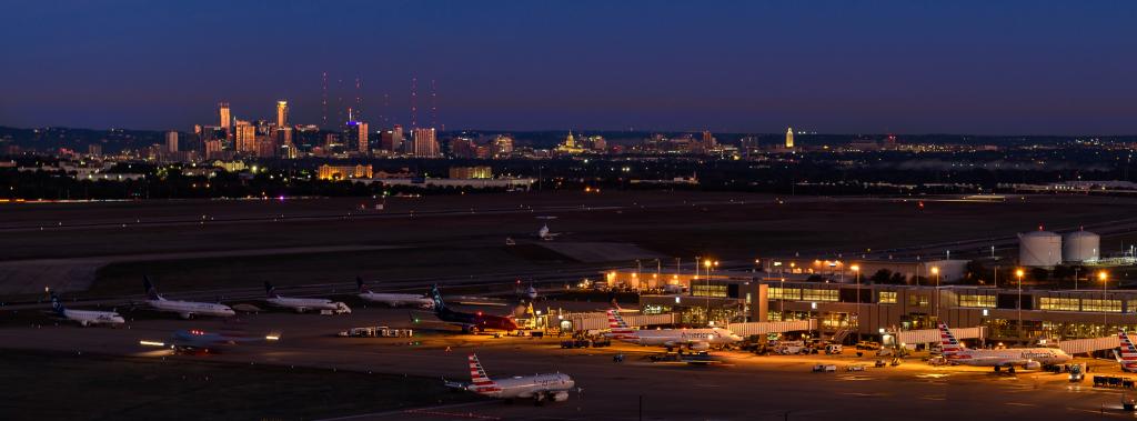 An image of the Barbara Jordan Terminal and the Austin skyline at night.