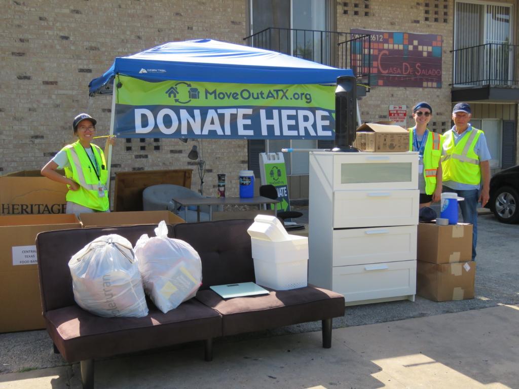 Volunteers stand at donation station.