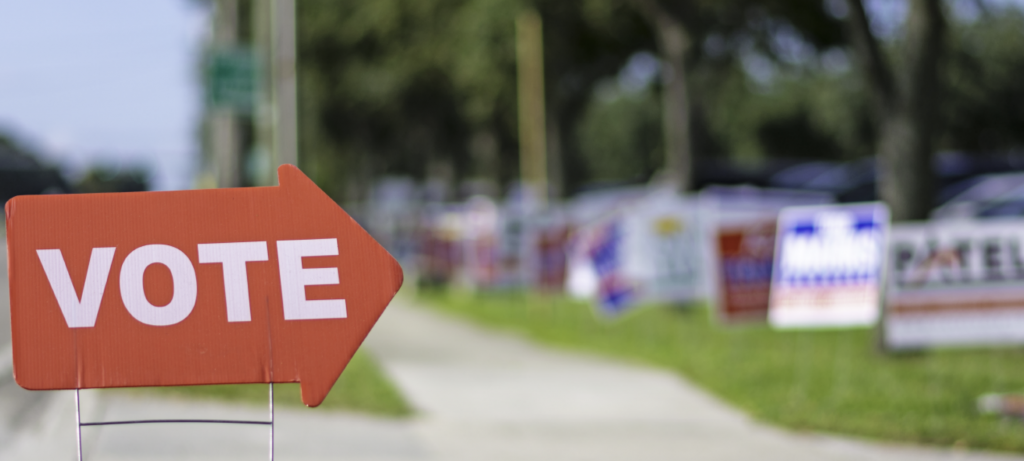Image of political signs outside a polling place