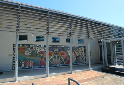 An outdoor plaza with a colorful mural.