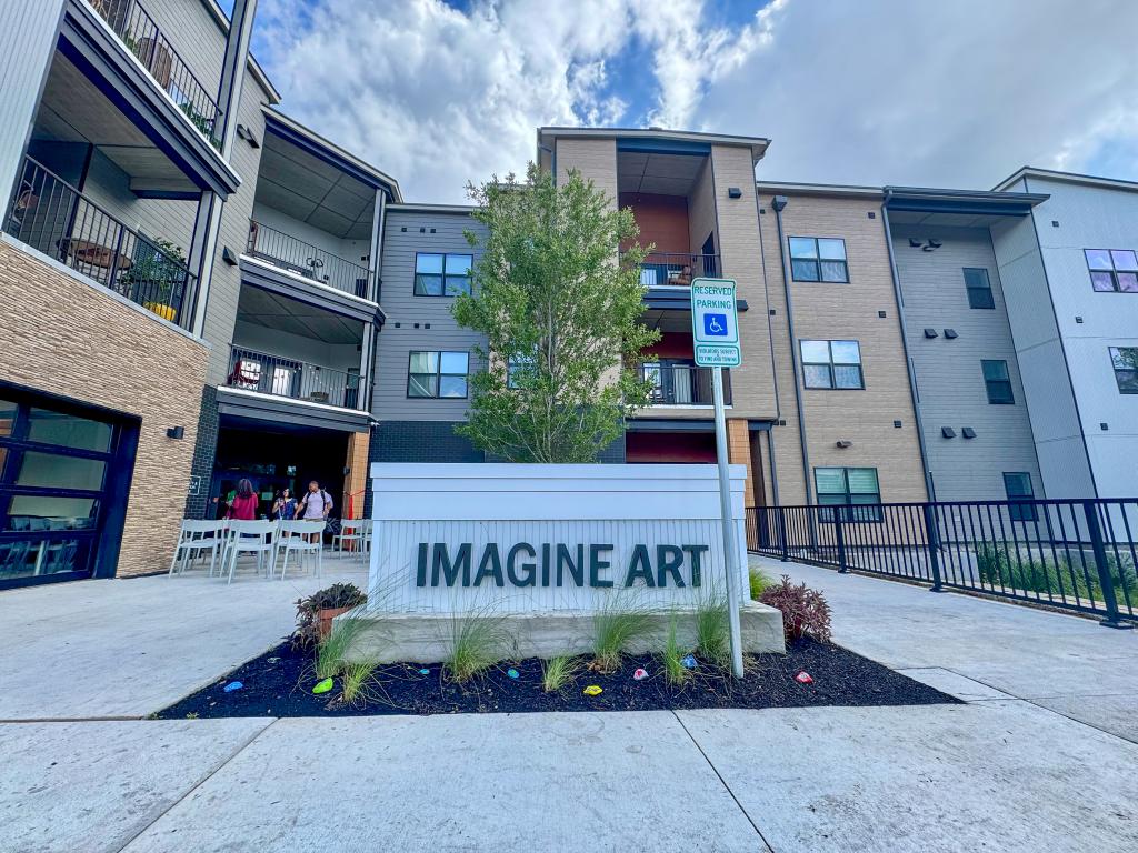 Imagine Art sign outside of Live Make Apartments 