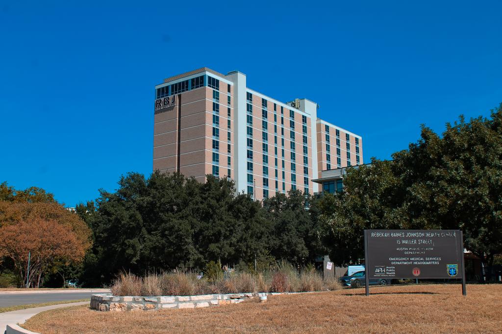 Exterior of the Rebekah Baines Johnson Health Center with sign in front and clear blue sky.