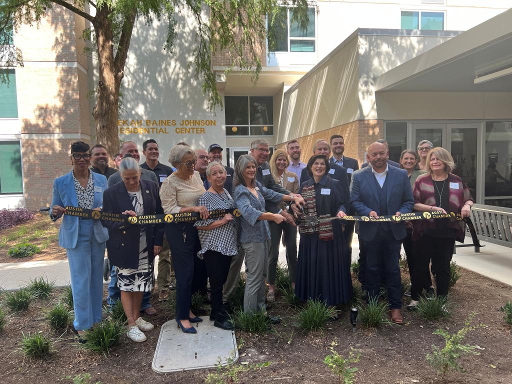 City and community leaders participate in a ribbon-cutting ceremony at the Rebekah Baines Johnson Residential Center grand reopening.