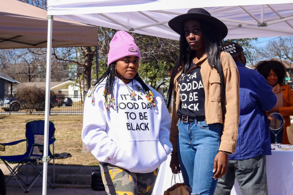 photograph of two women in matching shirts that say "it's a good day to be Black"
