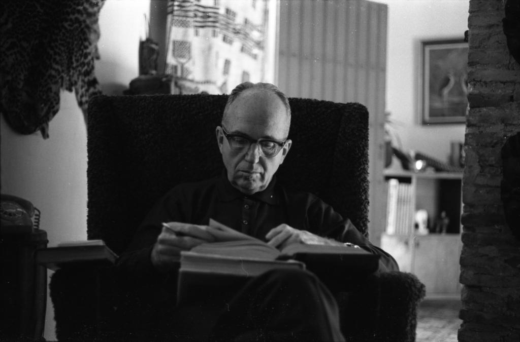 "James A. Michener reading a book circa 1960"