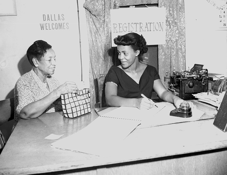 Williams at voter registration table with young woman