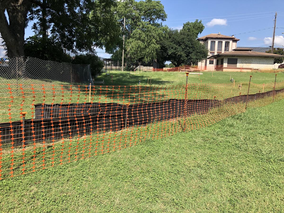 The beginning of construction starts with the construction fencing around the area.