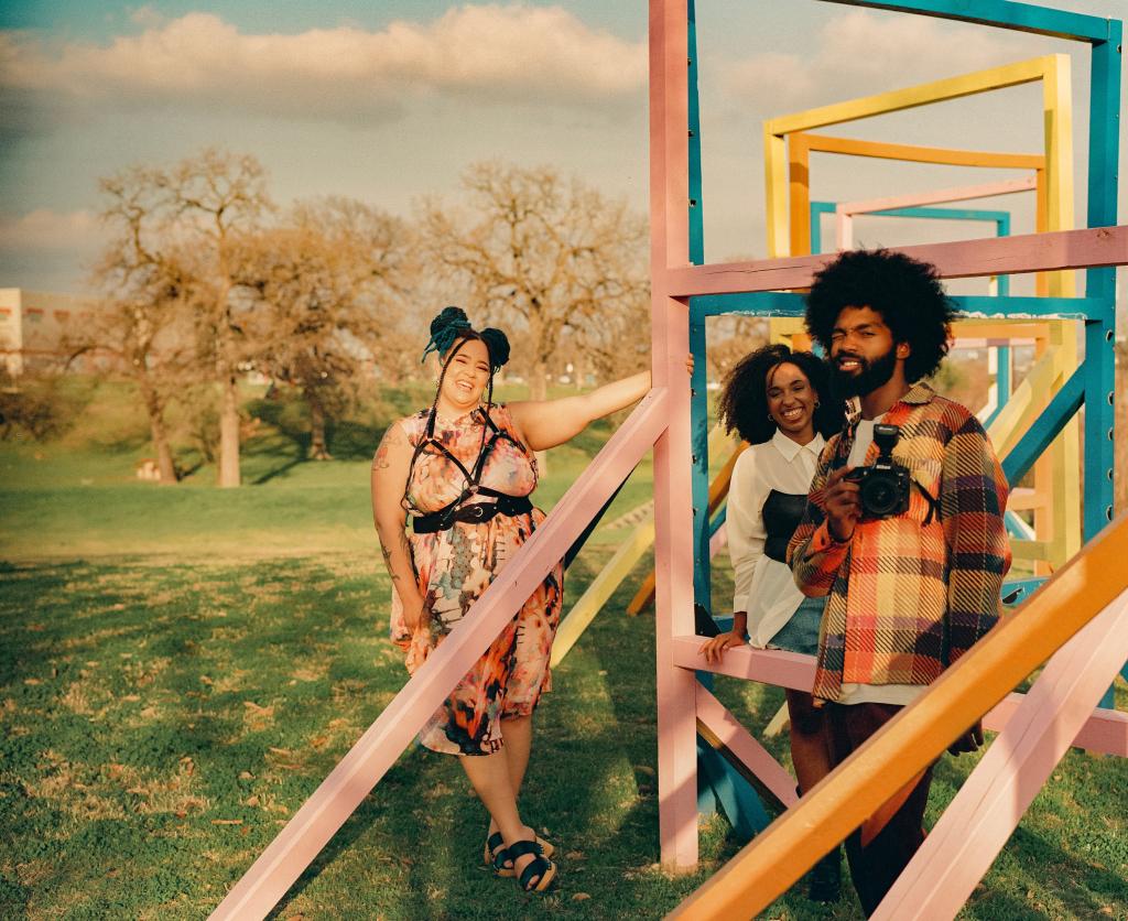 3 Black Artists posing outdoors near sculpture