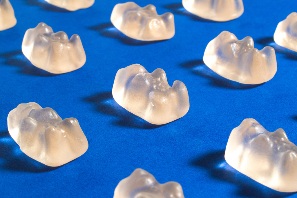 A photograph of gummy bears spaced out evenly on a backdrop