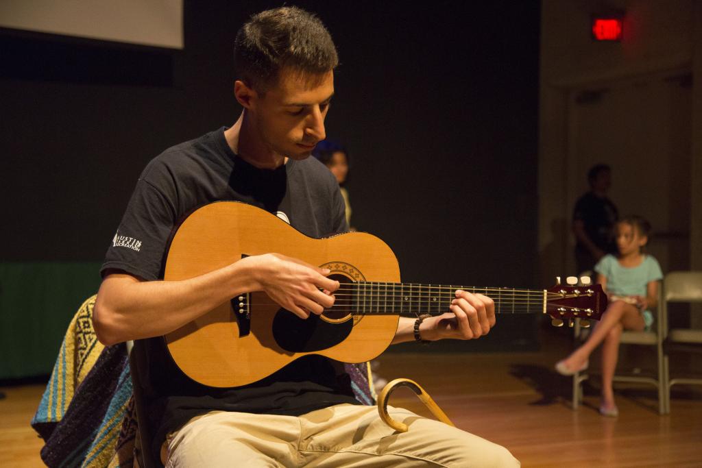 Photo of a spring break instructor playing the guitar 