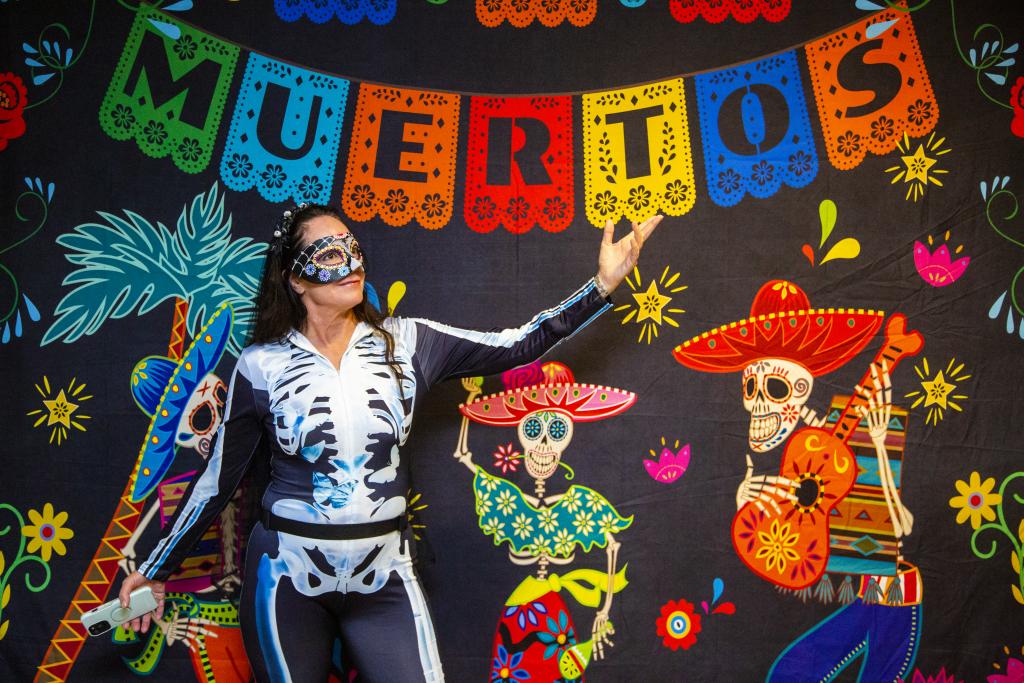 Day of the Dead decoration backdrop with a woman in front