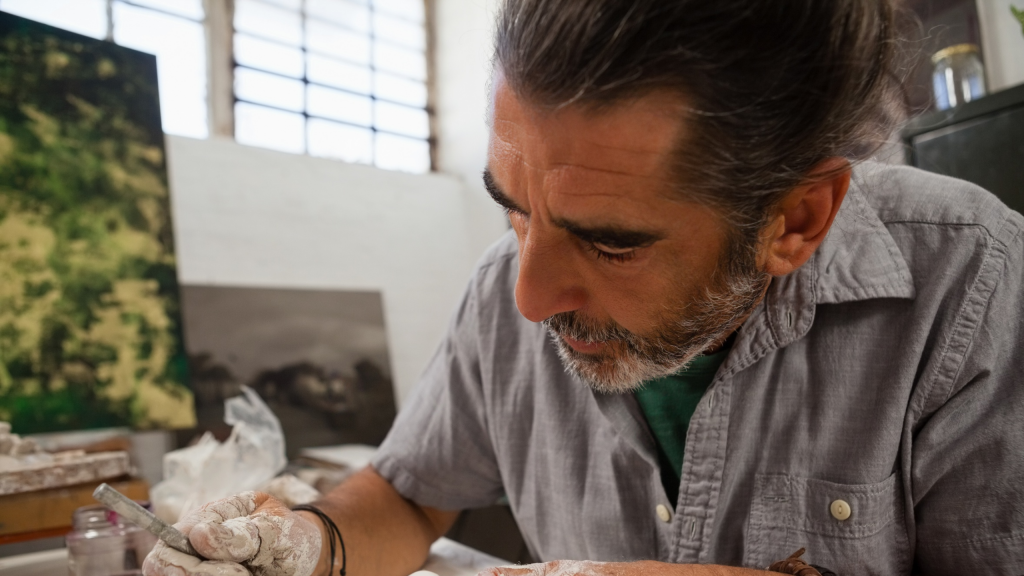 Sculptor working on a project in studio