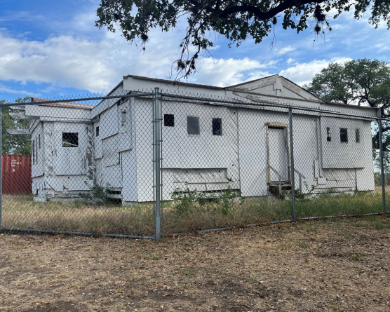 Photo of Norwood House in 2023 with construction fence