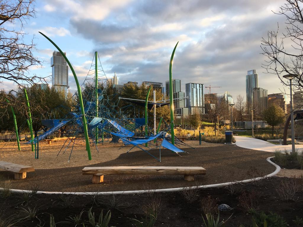 Image of new play equipment at Alliance Children's Garden with city skyline in the background