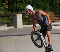 Person riding a bike up a ramp