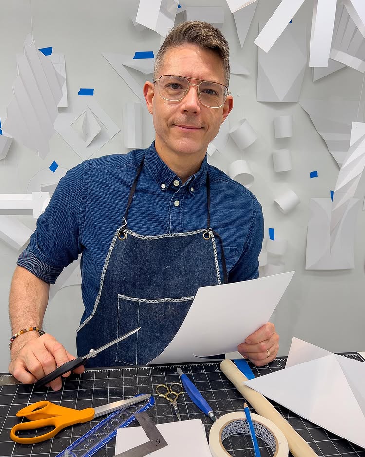 Artist Michael Velliquette with paper craft materials