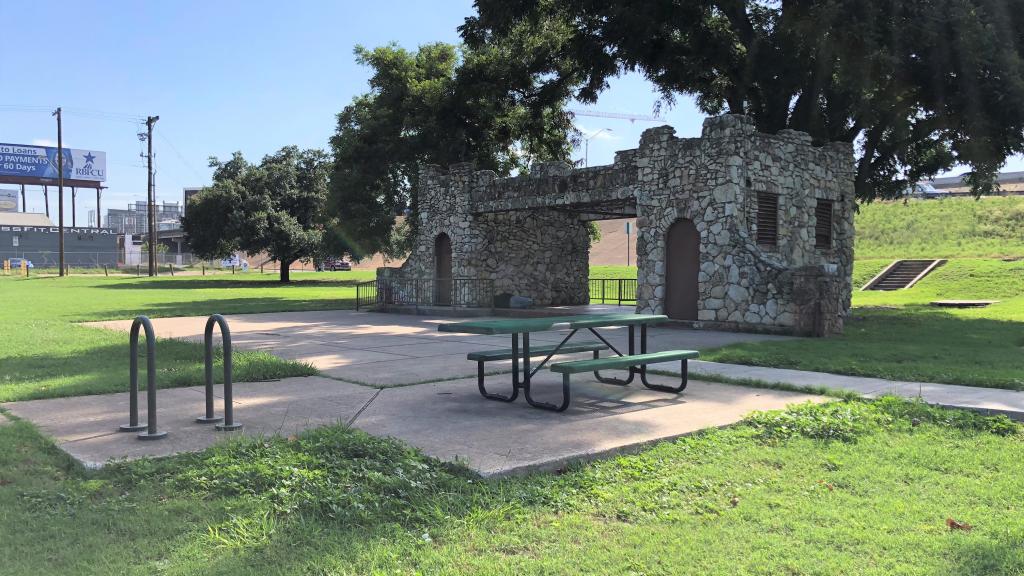 Image of historic restroom structure at Palm Neighborhood Park with picnic bench and bike rack