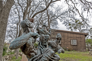 Image of sculpture in garden in front of house