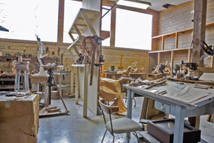 Image of artist studio showing easels and chairs and equipment