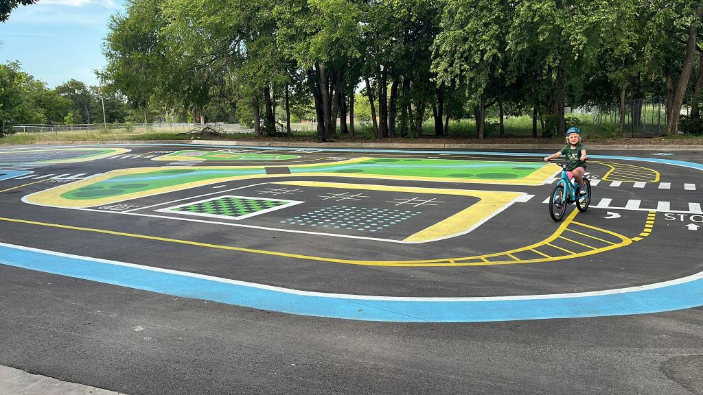 A child rides their bike on the new practice course