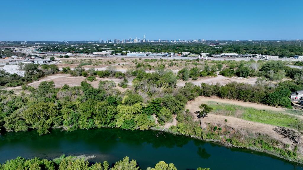 Aerial view of Bolm Park with Colorado River in foreground and Austin skyline in background