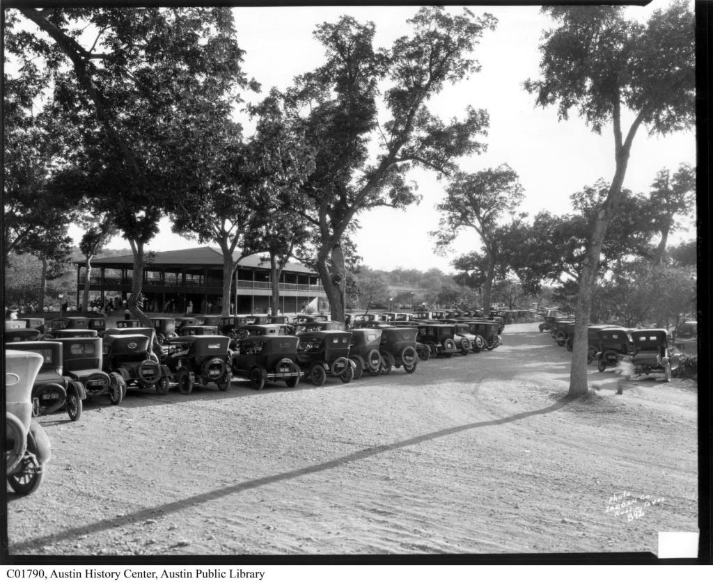 Image of rows of Model T cars parked in front of the old Barton Springs Bathhouse