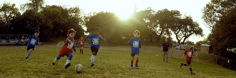 Youth kids playing soccer.