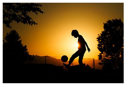 Child playing soccer