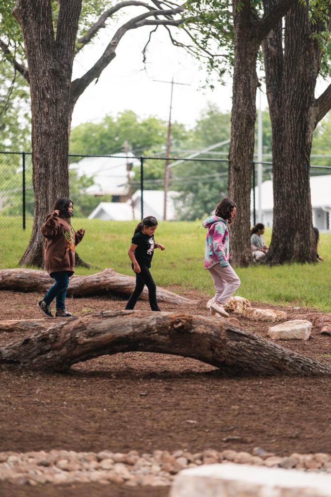Sanchez Elementary School Park, children balancing on logs