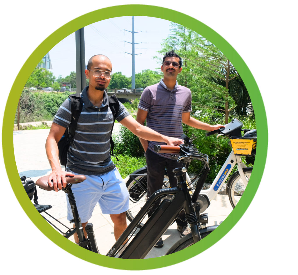 Sagar Kumashi and Saket Sripada stand behind their bikes in the Seaholm District.