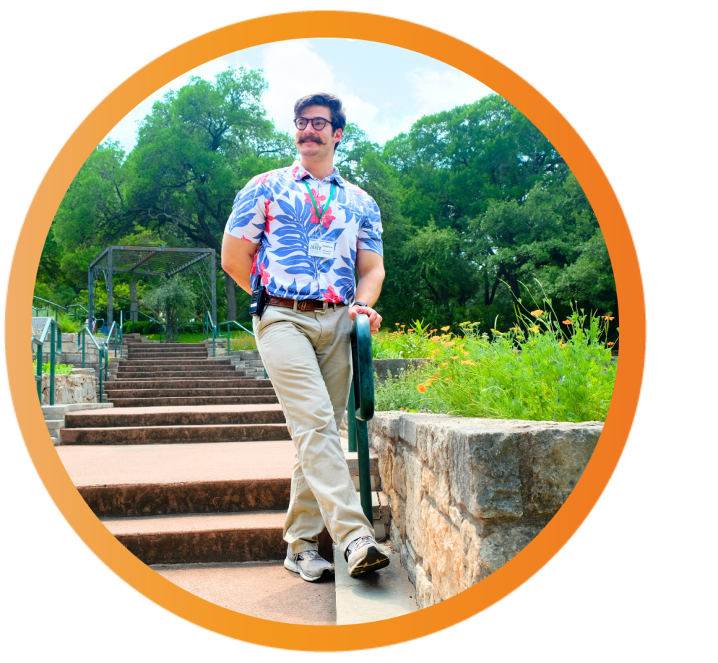 Matthew Gaston wears a colorful floral shirt in the edible garden at Zilker Botanical Garden.