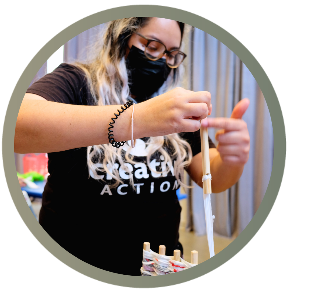 Kiana Salazar pulls a plastic bag through a loom.