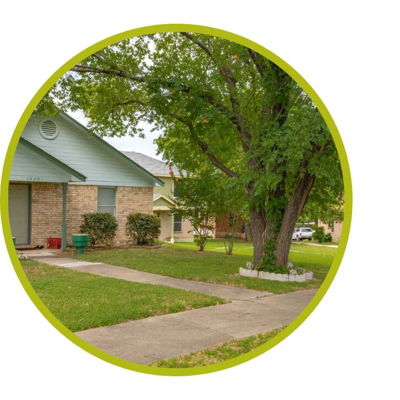 A home with a large oak tree in the yard.