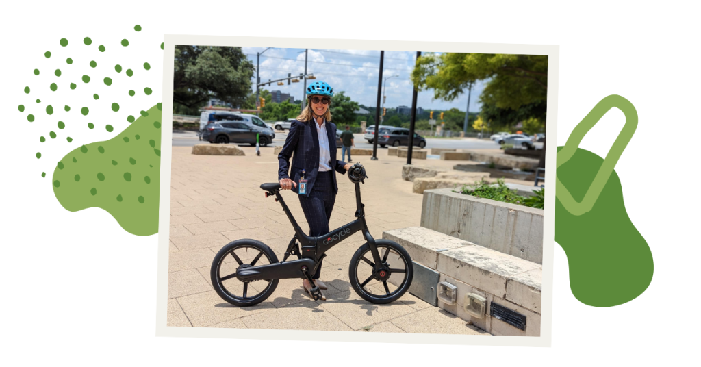 Sara stands outside City Hall in front of her bike with a helmet on.